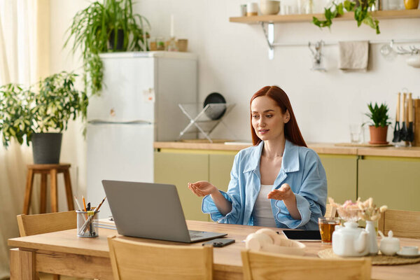 A red-haired woman teaches language lessons online from home, fostering a warm atmosphere.