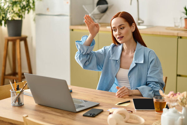 A woman with red hair teaches a language class online from her cozy home workspace.