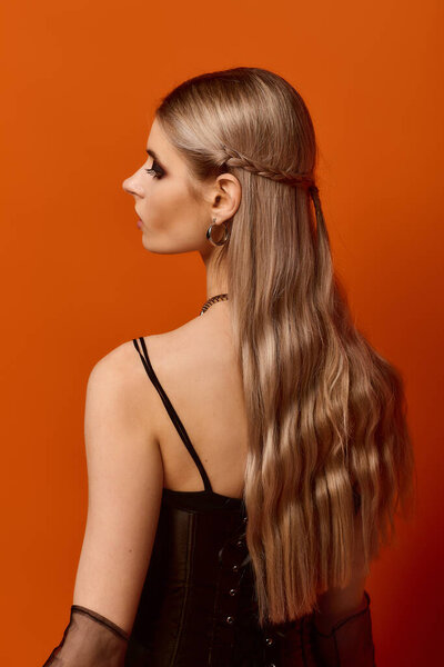 A stunning woman showcases her Halloween costume, with long hair flowing beautifully.