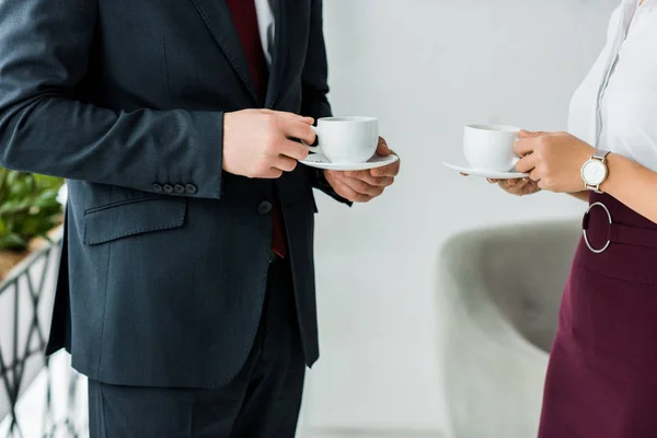 Cropped view of colleagues having coffee break on office — Stock Photo