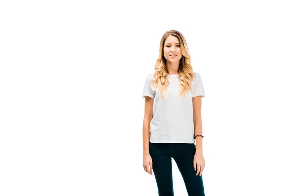 Beautiful blonde girl in white t-shirt standing and looking at camera isolated on white — Stock Photo