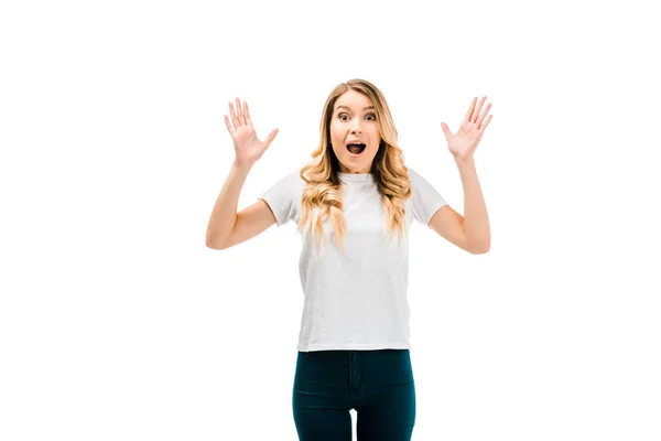 Shocked young woman gesturing with hands and looking at camera isolated on white — Stock Photo
