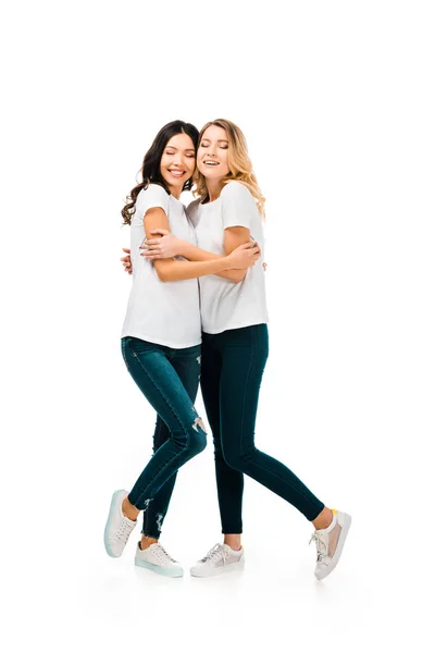 Volle Länge Ansicht der schönen glücklichen jungen Frauen umarmen isoliert auf weiß — Stockfoto