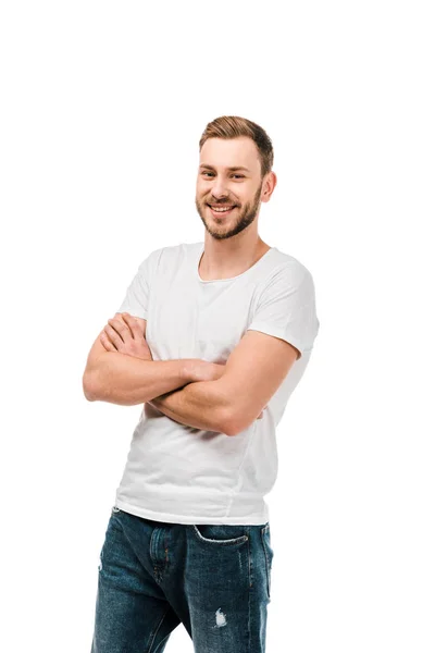 Handsome happy young man standing with crossed arms and smiling at camera isolated on white — Stock Photo