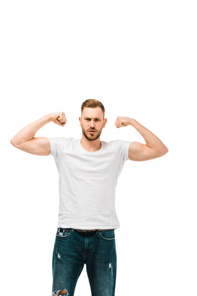 Handsome bearded young man showing biceps and looking at camera isolated on white — Stock Photo