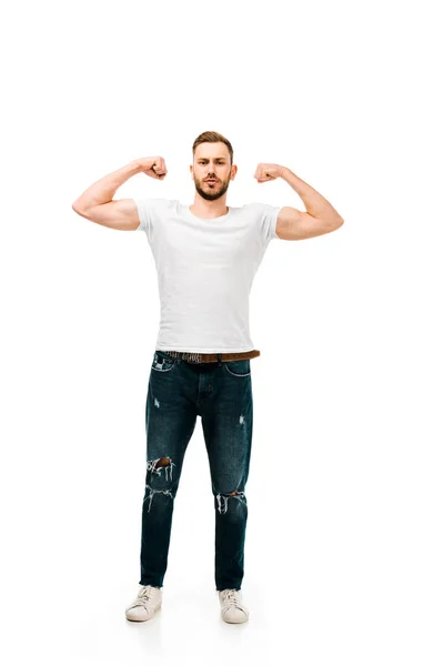 Full length view of handsome bearded young man showing biceps and looking at camera isolated on white — Stock Photo
