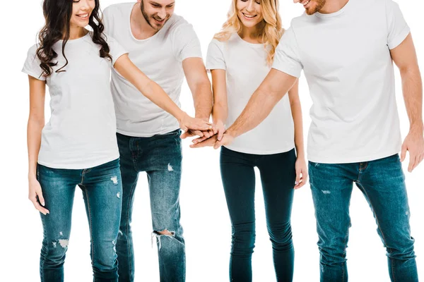 Plan recadré de jeunes hommes et femmes souriants empilant les mains isolées sur blanc — Photo de stock