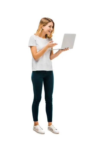 Full length view of beautiful happy young woman using laptop isolated on white — Stock Photo