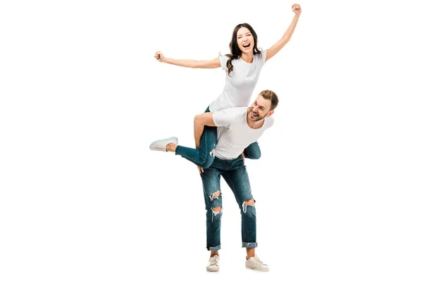 Joyeux jeune couple piggybackking et avoir du plaisir ensemble isolé sur blanc — Photo de stock