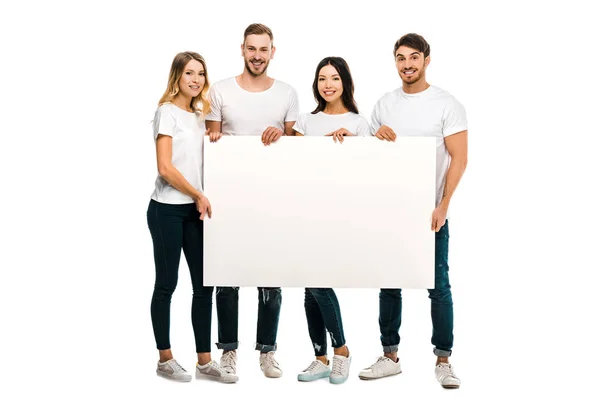 Happy young people holding blank placard and smiling at camera isolated on white — Stock Photo