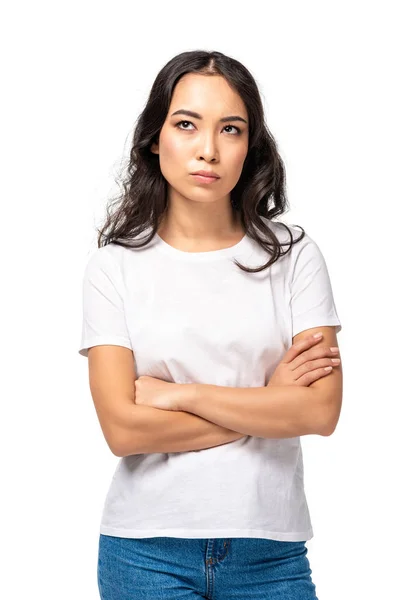 Skeptical dissatisfied asian woman standing with crossed arms isolated on white — Stock Photo