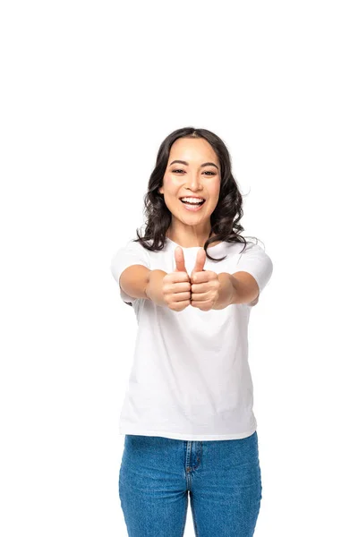 Smiling young asian woman holding hands together and showing thumbs up isolated on white — Stock Photo