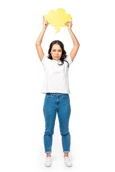 Offended asian woman in white t-shirt and blue jeans holding thought bubble isolated on white — Stock Photo