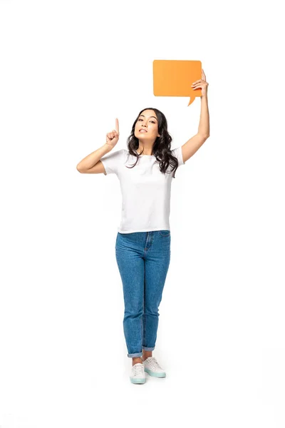 Smiling asian woman holding speech bubble and showing idea sign isolated on white — Stock Photo