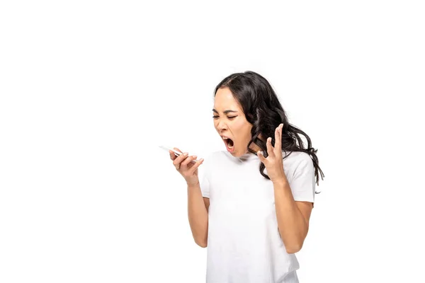 Yelling asian girl in white t-shirt and blue jeans using smartphone isolated on white — Stock Photo