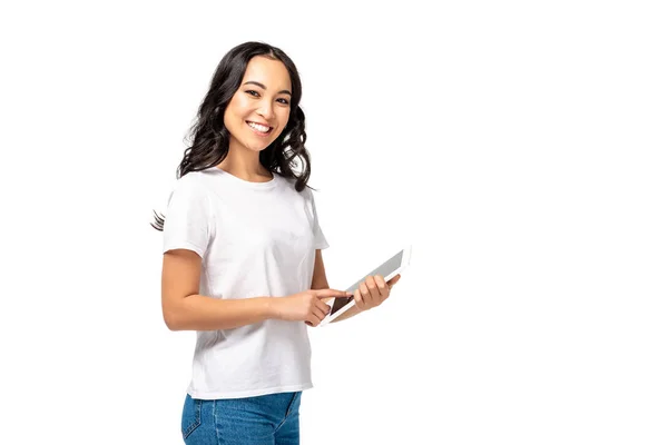 Smiling asian using digital tablet while looking at camera isolated on white — Stock Photo