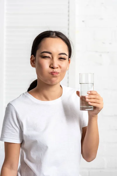 Jeune femme asiatique en t-shirt blanc rinçant la bouche avec de l'eau — Photo de stock