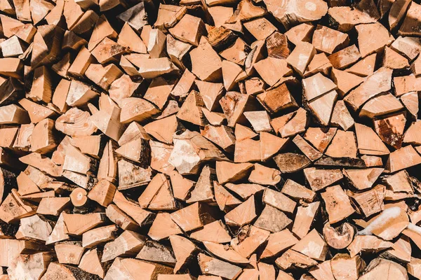 Pile of brown cut textured firewood at sunny day — Stock Photo