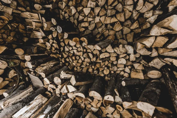 Pile of brown stacked textured cut firewood — Stock Photo