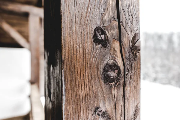 Selective focus of textured wooden plank on snowy background — Stock Photo