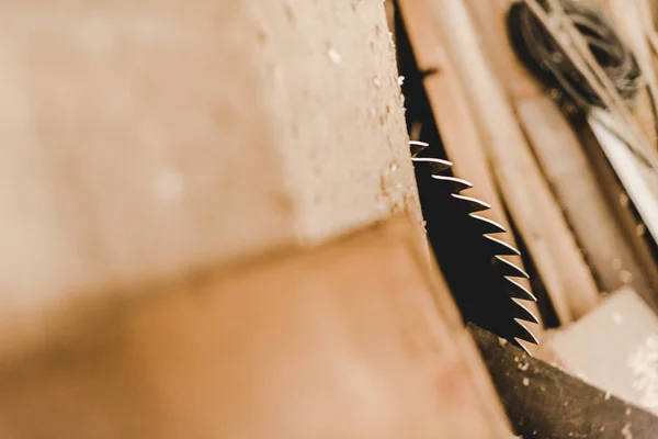 Selective focus of round metal saw disc cutting wooden plank — Stock Photo