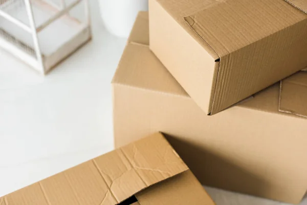 Brown cardboard boxes on light surface at home — Stock Photo