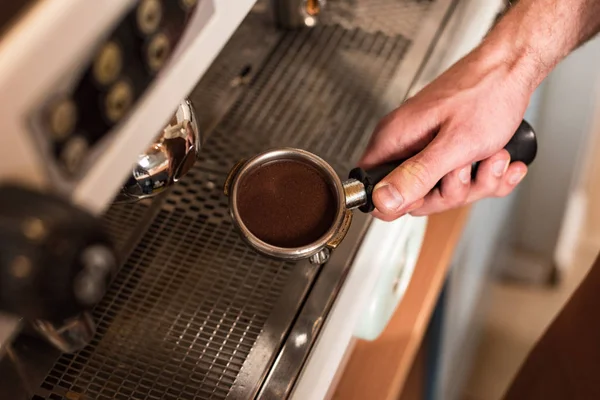 Cropped view of barista holding portafilter with ground coffee — Stock Photo