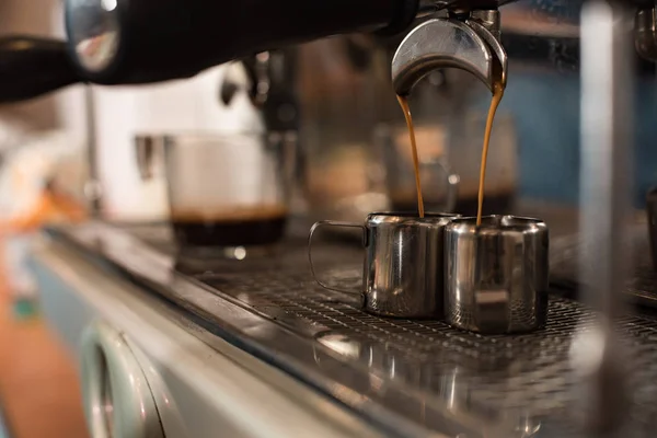 Selective focus of coffee machine and two stainless cups — Stock Photo