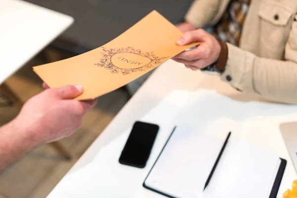 Cropped view of man and waiter holding menu in cafe — Stock Photo