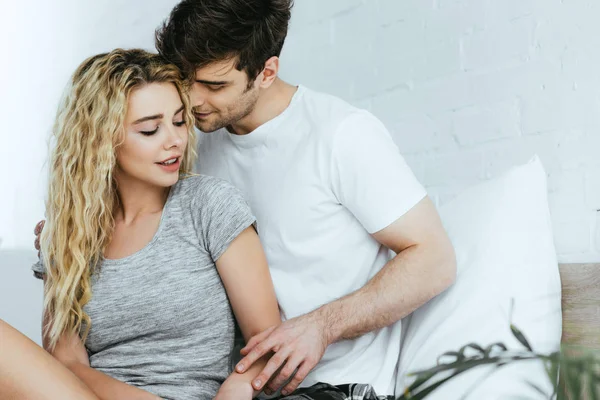 Handsome boyfriend touching blonde happy young woman — Stock Photo