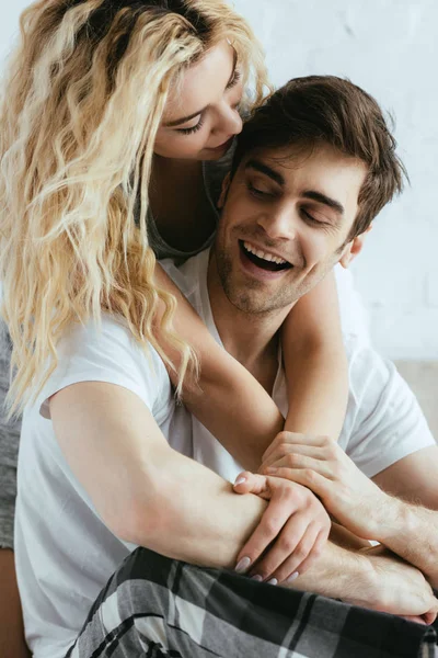 Attractive blonde girl hugging happy and handsome boyfriend — Stock Photo