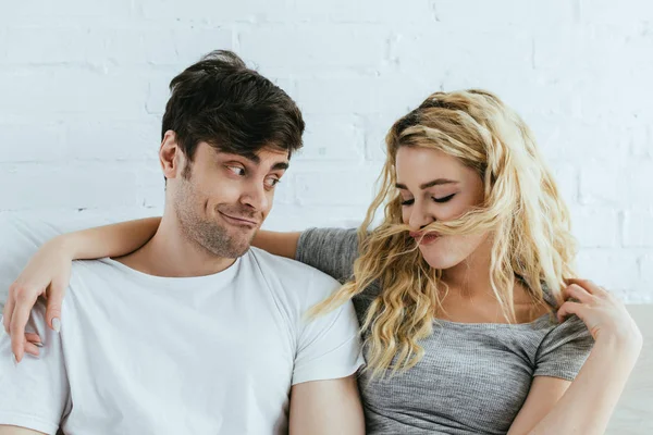 Handsome man looking at girl with blonde hair on face — Stock Photo