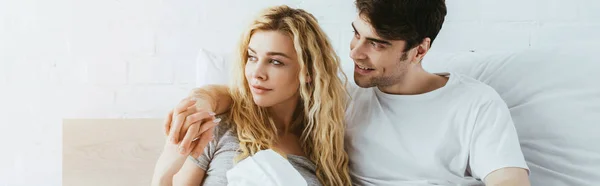 Panoramic shot of happy man holding hands with beautiful girlfriend — Stock Photo