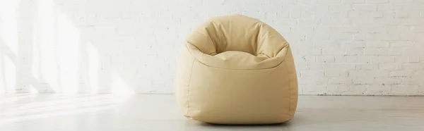 Panoramic shot of bean bag chair near brick wall in modern home — Stock Photo