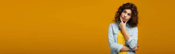 Panoramic shot of pensive woman thinking while standing on orange — Stock Photo