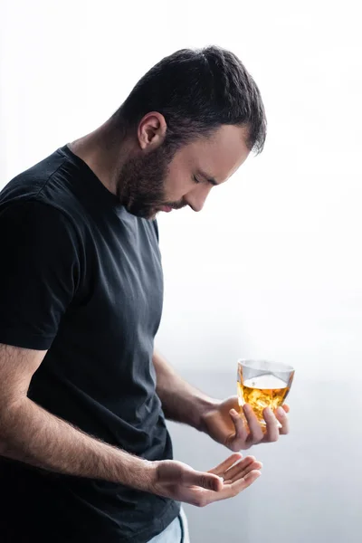 Depressiver bärtiger Mann mit geschlossenen Augen und einem Glas Whiskey — Stockfoto