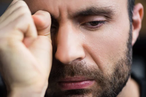 Portrait of handsome crying man wiping tears away with hand — Stock Photo