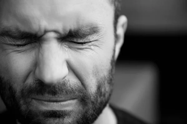 Black and white portrait of handsome bearded man crying with closed eyes — Stock Photo