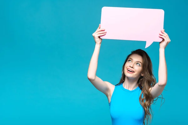 Charming girl in swimsuit holding speech bubble isolated on blue — Stock Photo