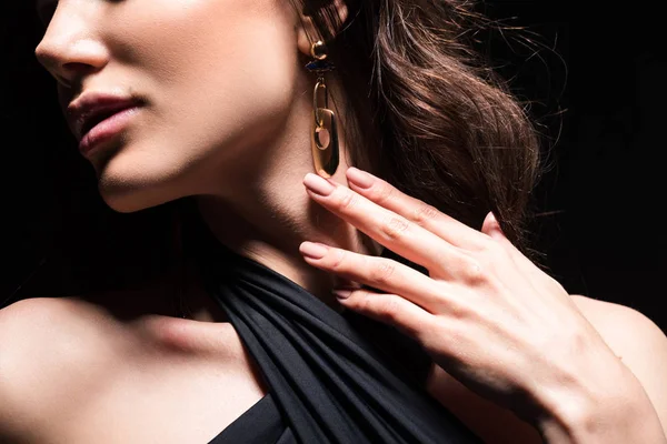 Cropped view of woman gently touching earring isolated on black — Stock Photo