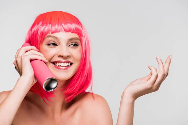 Fashionable girl in pink wig holding hair spray, isolated on grey — Stock Photo