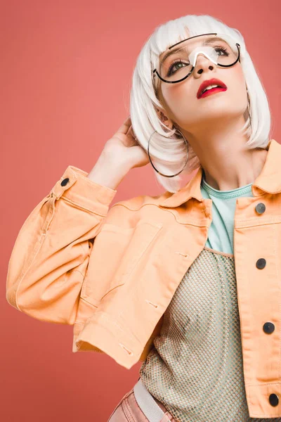 Attractive young woman posing in white wig isolated on pink — Stock Photo