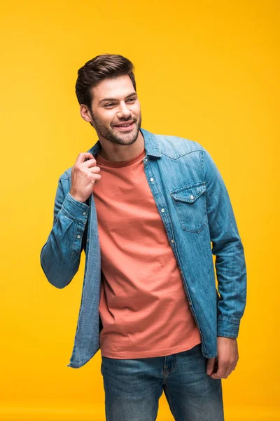 Smiling good-looking man posing isolated on yellow — Stock Photo