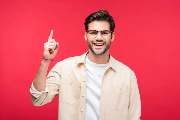 Smiling handsome man pointing with finger up Isolated On pink — Stock Photo