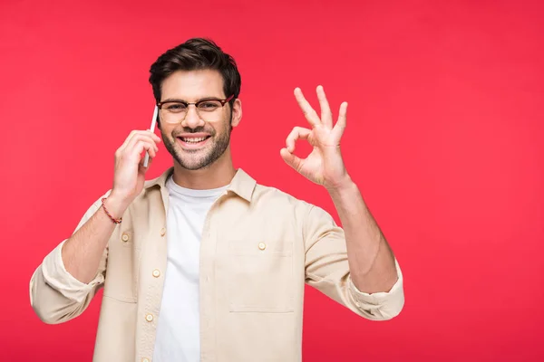 Happy man talking on smartphone and doing OK Sign Isolated On pink — Stock Photo
