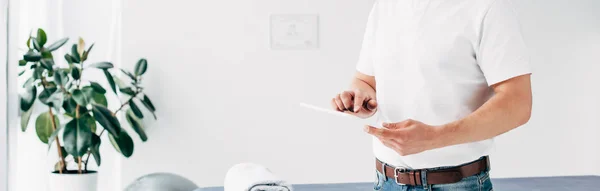 Panoramic shot of chiropractor in hospital using Digital Tablet — Stock Photo