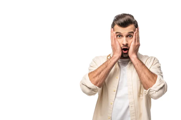 Uomo sorpreso guardando la fotocamera e toccando il viso isolato su bianco con spazio di copia — Foto stock