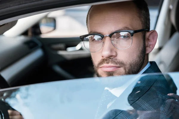 Selective focus of handsome bearded man in glasses — Stock Photo