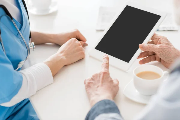 Cropped view of hands pointing at digital tablet with copy space — Stock Photo