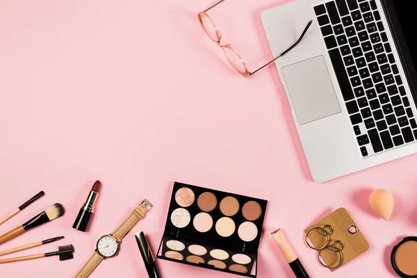 Top view of laptop, accessories and decorative cosmetics on pink — Stock Photo